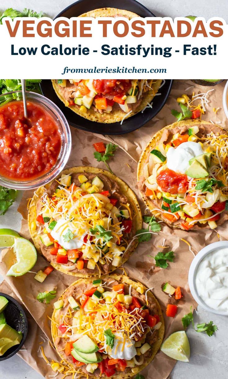 three tacos with salsa and sour cream in the middle, on top of a table