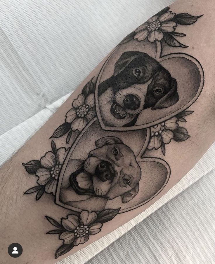 a black and white photo of a dog in a heart with flowers on it's leg