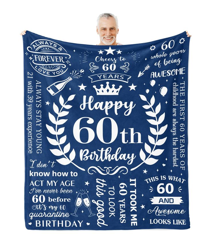 a man holding up a blue birthday blanket with the words happy 60th and crown on it