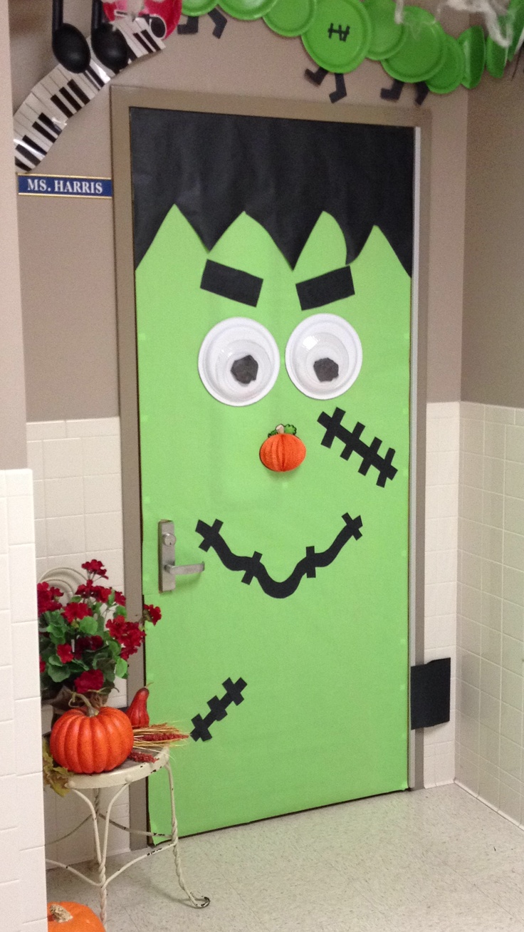 a green door decorated to look like a monster