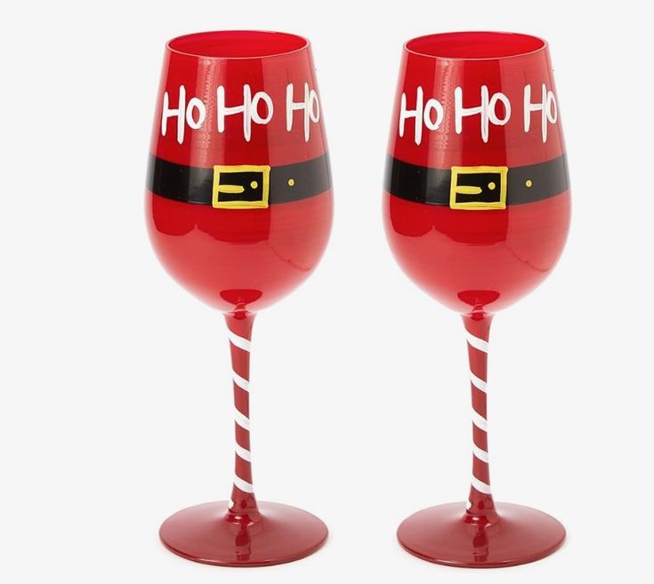 two red wine glasses with santa hats and candy canes painted on the bottom one