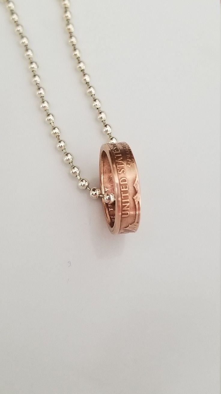 A handmade coin ring necklace made from a US Copper Penny. It has a natural Copper patinas and is coated with a clear sealant to maintain the current finish. It Is hanging on an 16-20 Inch  Sterling Silver Plated Chain. What a great way to celebrate one's Birthday, Anniversary or any  other special occasion with this handcrafted Double sided Coin Ring  made from a Penny. This Ring comes with a Ball Chain Necklace. Hand Made In The USA!!Each ring will be sealed with a jewelry sealer,  which helps Nickel-free Jewelry For Anniversary Gift, Stamped Rose Gold Round Pendant Jewelry, Stamped Round Pendant Jewelry For Anniversary Gift, Stamped Rose Gold Round Jewelry, Stamped Jewelry With Round Pendant For Anniversary, Handmade Coin Jewelry For Anniversary, Penny Jewelry, Copper Penny, Penny Coin