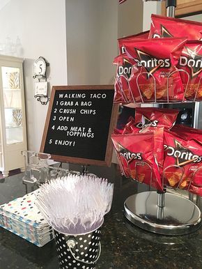 there is a sign that says donuts and chips on the counter in front of it