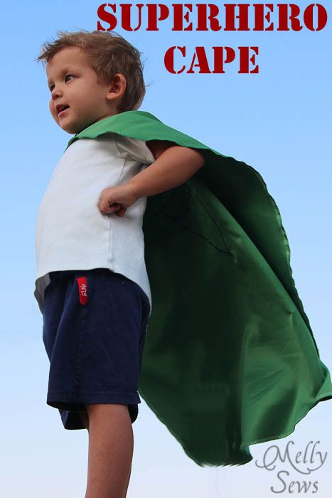 a young boy dressed up as a superhero with the words super hero cape over his shoulders