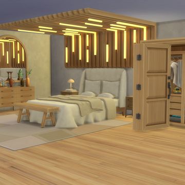 a bedroom with a bed, dresser and dressing table in it's center area