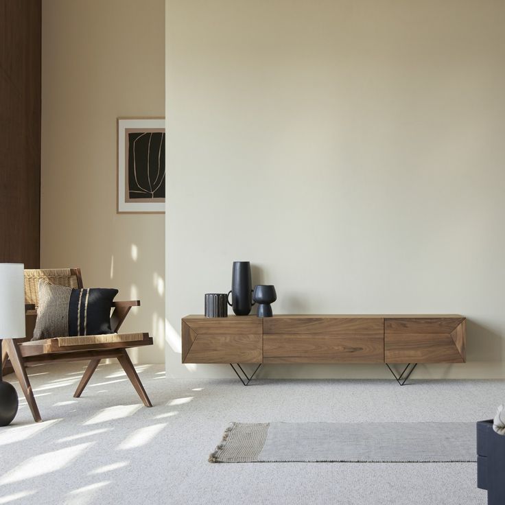 a living room scene with focus on the entertainment center and table in the foreground