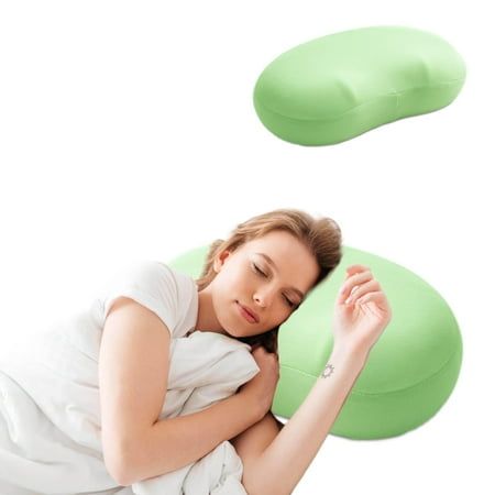 a woman laying on top of a green pillow