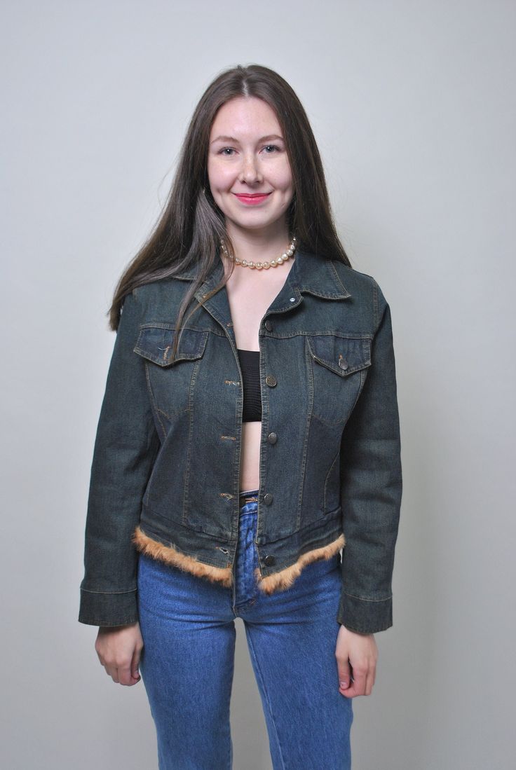 Step back into the iconic era of 90s grunge with our vintage denim jacket, a timeless piece that exudes effortless cool. Crafted from a durable blend of denim and polyester, this jacket combines classic style with modern versatility. With its button-up design and relaxed fit, this jacket offers both comfort and style. The medium size fits just right, with measurements of  40cm / 15.74inch sleeve length (armpit to end of sleeve),  47cm / 18.5inch; waist, and 52cm / 20.48 length all taken seam to Vintage Outerwear With Frayed Hem For Fall, Trendy Winter Denim Jacket With Frayed Hem, Fitted Grunge Winter Outerwear, Winter Fitted Denim Jacket With Button Closure, Fitted Denim Jacket With Button Closure For Winter, Y2k Denim Jacket For Fall Streetwear, Fitted Winter Outerwear With Frayed Hem, Vintage Outerwear With Frayed Hem And Long Sleeves, Vintage Long Sleeve Outerwear With Frayed Hem