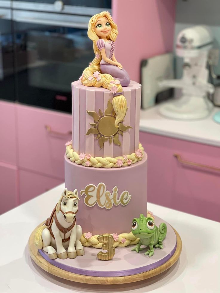 there is a cake that has a princess on top and other animals around the bottom