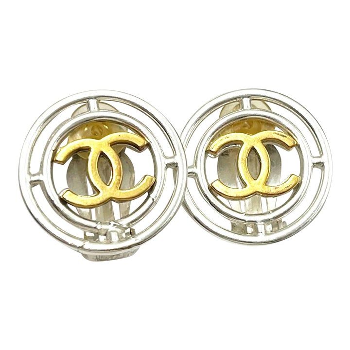 Chanel Vintage Gold Plated CC Silver Round Wheel Clip on Earrings  *Marked 96 ( Missing one hallmark) *Made in France  -Approximately 0.9″ x 0.9″ -It shows some color changing on the metal. -In a good vintage condition  AB1986-00478  Please see the measurements section for best approximate dimensions. Designer Formal Earrings With Polished Finish, Designer Polished Finish Earrings For Formal Occasions, Designer Clip-on Round Earrings, Designer Round Clip-on Earrings, Designer Round Silver Earrings, Designer Silver Clip-on Earrings, Designer Silver Round Earrings, Designer Polished Finish Earrings For Anniversary, Designer Clip-on Earrings For Anniversary