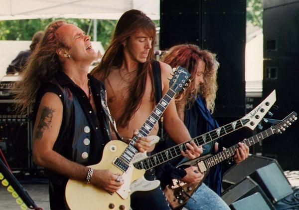 two men are playing guitars on stage