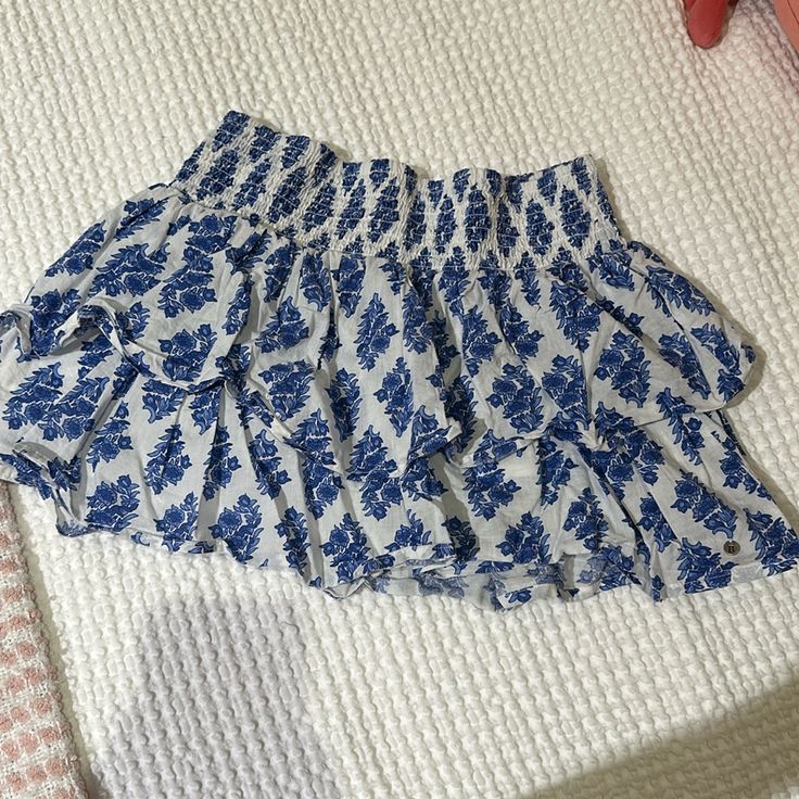 Brand New Brownie Blue And White Mini Skirt With Shorts Blue Mini Skirt Bottoms For Summer, Light Blue Floral Print Bottoms For Vacation, Vacation Light Blue Floral Print Bottoms, Light Blue Casual Mini Skirt, Blue Floral Print Bottoms For Day Out, Blue Bottoms For Brunch In Spring, Blue Shorts For Brunch, Silk Mini Skirt, Feather Skirt