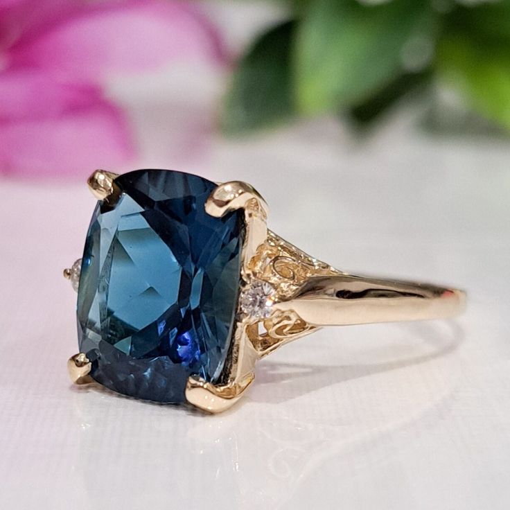 5.60 Carat Natural London Blue Topaz & Diamonds 14k Solid Gold Ring  Ring Material: 14k Solid Gold  Total Metal Weight: 3.8 Grams  Gemstone: Natural London Blue Topaz Gemstone Color: Dark Blue  Gemstone Shape: Cushion Gemstone Dimensions: 12.00x10.00 mm Gemstone Carat Weight: 5.52 Carat Gemstone Quantity: 1 Natural Round Shaped Diamonds Diamonds Quantity: 2 Diamonds Total Carat Weight: 0.08 Carat Total Carat Weight: 5.60 Carat Ring Quantity: One  Condition: New Delivered in an elegant gift box M Sapphire Topaz Ring With Accent Stones For Formal Events, Blue Topaz Ring With Gemstone Accents In 14k Gold, Luxury Blue Cushion Cut Topaz Ring, Blue Cushion Cut Rings For Formal Occasions, Formal Blue Diamond Birthstone Ring, Elegant Blue Diamond Ring In 14k Gold, Blue Cushion Cut Diamond Ring For Formal Occasions, Elegant Blue Sapphire Ring In 14k Gold, Formal Sapphire Diamond Ring With Gemstone Accents