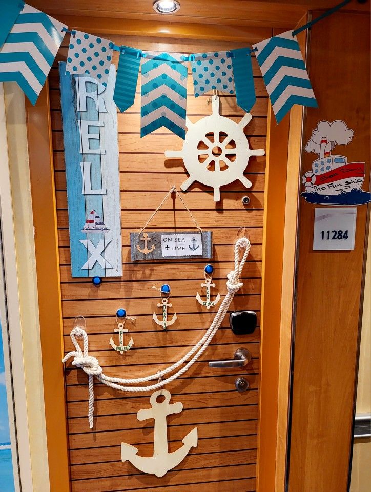 a door with an anchor, steering wheel and other items hanging on the front wall