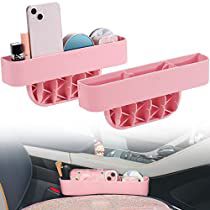 two cell phone holders are attached to the dashboard of a car, and one is filled with various items