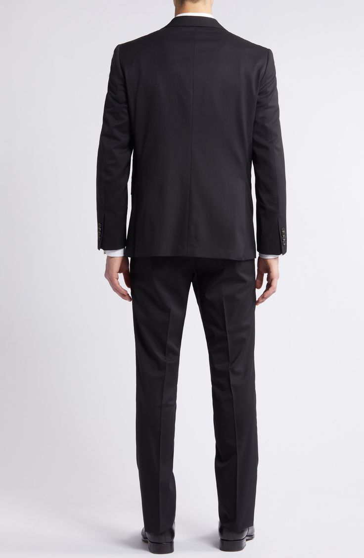 Crisp and classic, this suit tailored from black wool features traditional detailing and makes a versatile, polished addition to any formal wardrobe. Jacket has notched lapels; four-button cuffs; chest pocket; flap pockets; side vents Trousers have zip fly with button-tab closure; slant pockets; back button-welt pockets Jacket is lined; trousers are lined to the knee Unhemmed 100% wool Dry clean Made in Canada Black Wool Suit With Welt Pockets, Black-tie Suits With Welt Pockets And Lapel Collar, Tailored Notch Lapel Tuxedo With Double-breasted Button Fastening, Black Wool Single-breasted Tuxedo, Black-tie Blazer With Welt Pockets And Notch Lapel, Hairstyling Products, Rollerball Perfume, Pocket Jacket, Tailored Suits