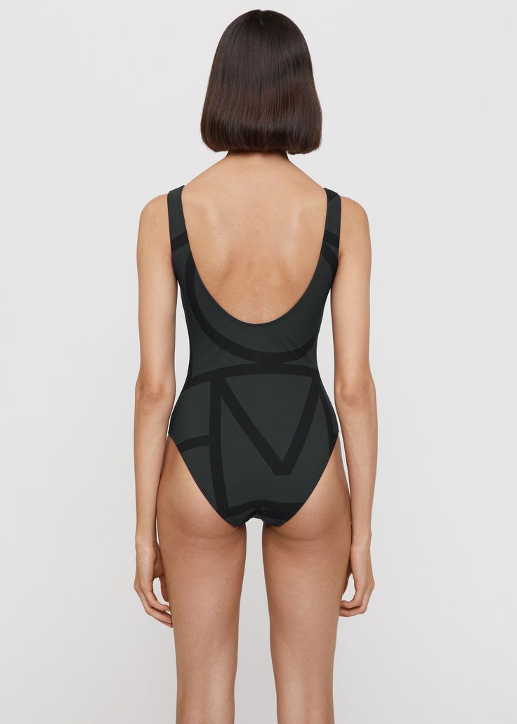 Totême swimsuit in a recycled polyamide fabric with a four-way stretch and a SPF construction. It’s designed for a close fit and shaped to a classic silhouette with a deep u-back and high-cut legs. Pack with Monogram jacquard beach towel on your next beach getaway. Second-skin Black Swimwear For The Beach, Second-skin Fit Black Swimwear For Beach, Black Swimwear With Minimal Stretch For Swimming, Black Swimwear With Minimal Stretch, Black Swimwear For Swimming, Black Seamless Swimwear For Swimming, Black Polyamide Swimwear For Pool, Minimal Stretch Black Swimwear, Black Swimwear With Minimal Stretch For Pool