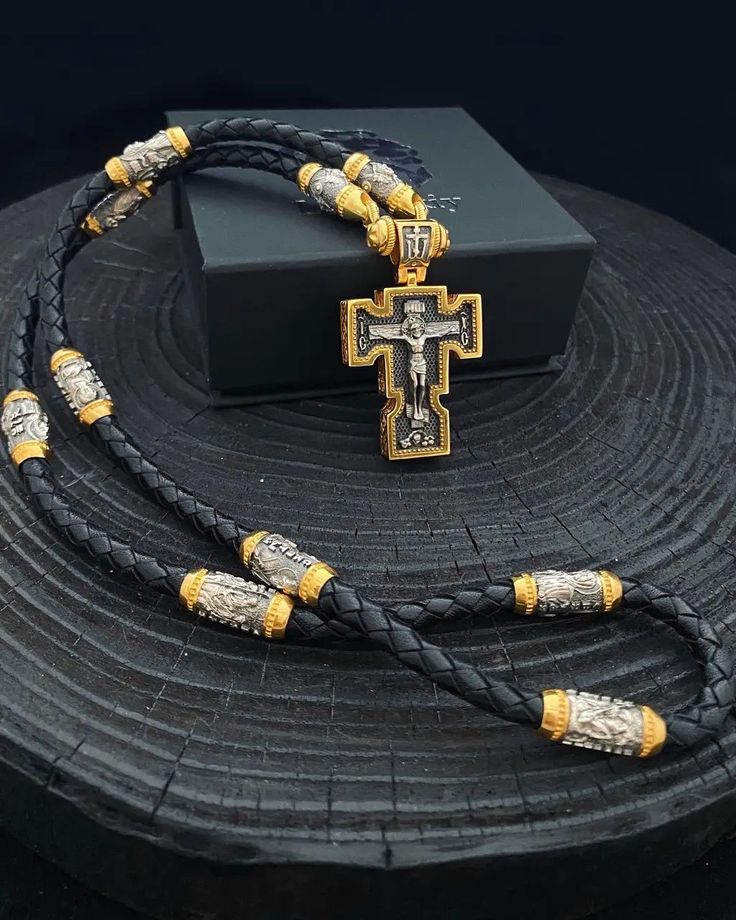 Total weight +- 90 grams 1️⃣ Silk cord with 8 gilded silver inserts depicting the faces of Saints. ✔️925 silver + 24K gold plated + blackening ✔️Lace diameter 5.5 mm. ✔️Length 60 cm/ 23,6 inches ✔️Inserts: 🔘Nicholas the Wonderworker 🔘Holy Trinity 🔘George the Victorious 🔘Mother of God 🔘Panteleimon the Healer 🔘Sergei Radonezhsky 🔘Holy Matrona 🔘Jesus Christ ✔️Endings with Jesus Christ and carabine 2️⃣Silver and gilded Cross Art. 0151 The cross depicts ✔️Jesus Christ and Archangel Michael. ✔ Gold Leather Necklace For Gift, Luxury Silver Cross Necklace As Gift, Luxury Silver Cross Necklace For Gift, Byzantine Crucifix Necklace As A Gift, Traditional Leather Jewelry As Gift, Traditional Leather Jewelry For Gifts, Luxury Pendant Cross Necklace Gift, Luxury Handmade Cross Jewelry, Luxury Cross Necklace As Gift