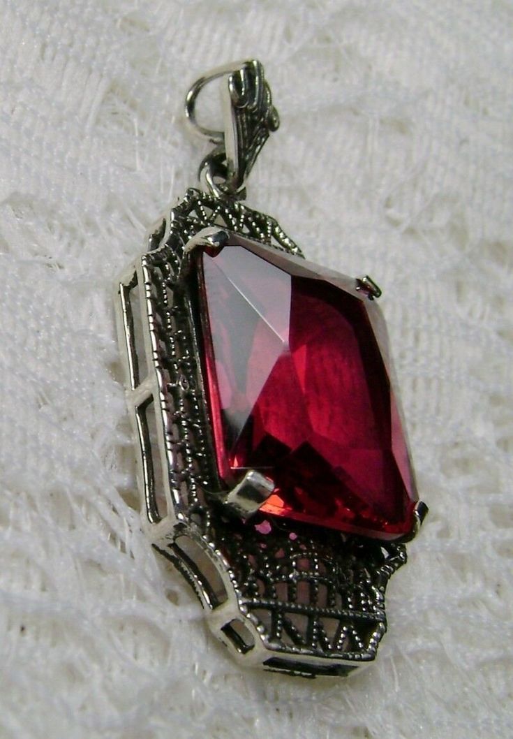 "Simulated Red Ruby Pendant Lantern Design#P13 Custom Made About 6 months ago I found a lovely Art Deco brooch and fell in love with the design. Fashioned in the design of the brooch, I now offer this lovely Antique reproduction pendant in sterling silver (matching 18ct earrings also available for sale). The flawless Simulated 9ct red/pink ruby is 15mm long (just over 9/16\") and 12mm in width (1/2th\"). The pendant is 1 3/8th inches long, it is 9/16th\" wide. The bail opening is 3.5mm wide and Classic Red Hallmarked Necklace, Classic Evening Ruby Jewelry, Antique Rectangular Formal Necklace, Ornate Red Pendant Jewelry, Classic Red Pendant Necklace, Vintage Ruby Evening Jewelry, Antique Ruby Necklace For Formal Occasions, Vintage Ruby Necklace For Formal Occasions, Victorian Ruby Necklace For Formal Occasions