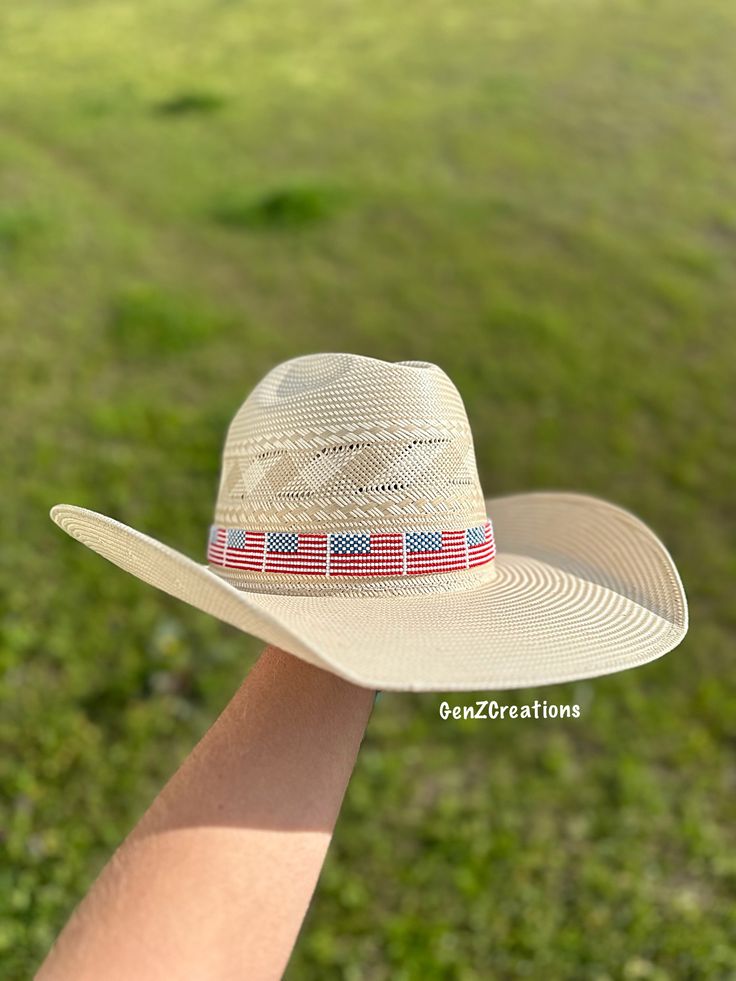 The USA Hatband is a stylish and patriotic accessory that adds a touch of flair to any hat. Hand-beaded with precision, this hatband represents American pride and heritage. Show off your love for the USA with this unique addition to your wardrobe. Whole Hatband - 35 inches Beaded Portion - 20 inches Patriotic Adjustable Hat For Independence Day, Adjustable Americana Hat For 4th Of July, Adjustable Patriotic Hats, Adjustable White Hat For 4th Of July, Patriotic American Flag Hats With Adjustable Fit, Adjustable American Hat With Curved Brim, Adjustable Hats With Curved Brim For 4th Of July, Adjustable Americana Hats For Country Events, American Style Adjustable Hat With Flat Brim