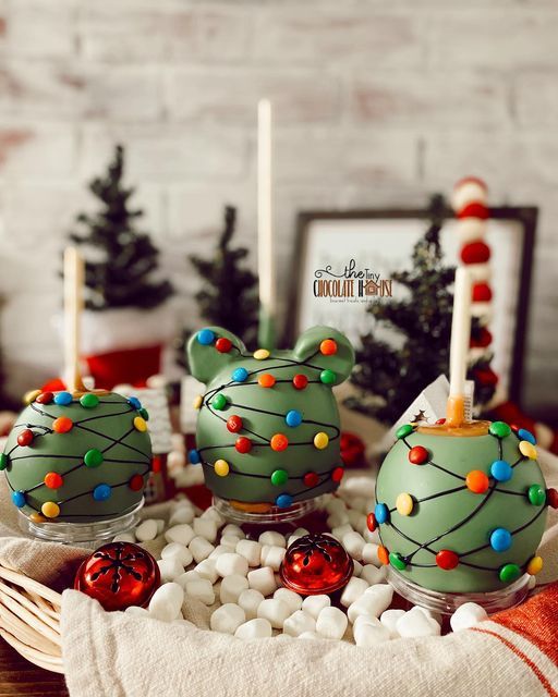 some green cake pops with christmas decorations on them