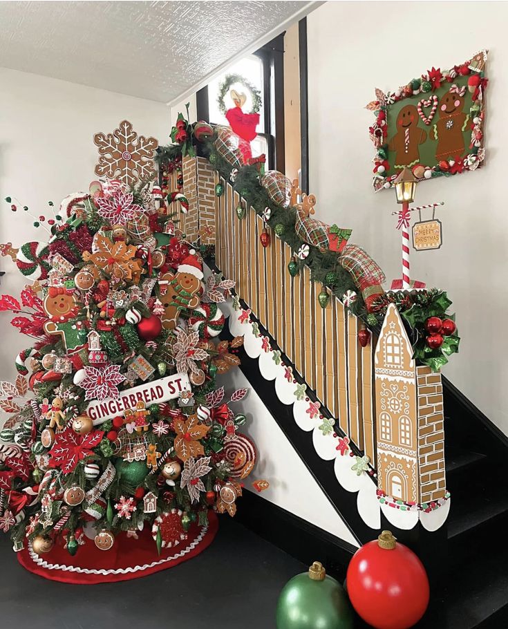 a decorated christmas tree sitting on top of a stair case