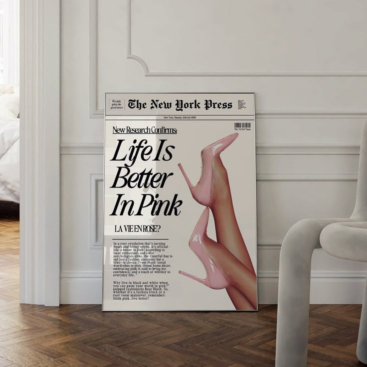 an advertisement for the new york times in front of a white chair and bed with pillows