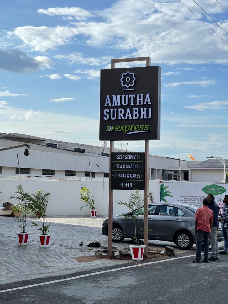 people are standing in front of the sign for amutha surabhi express