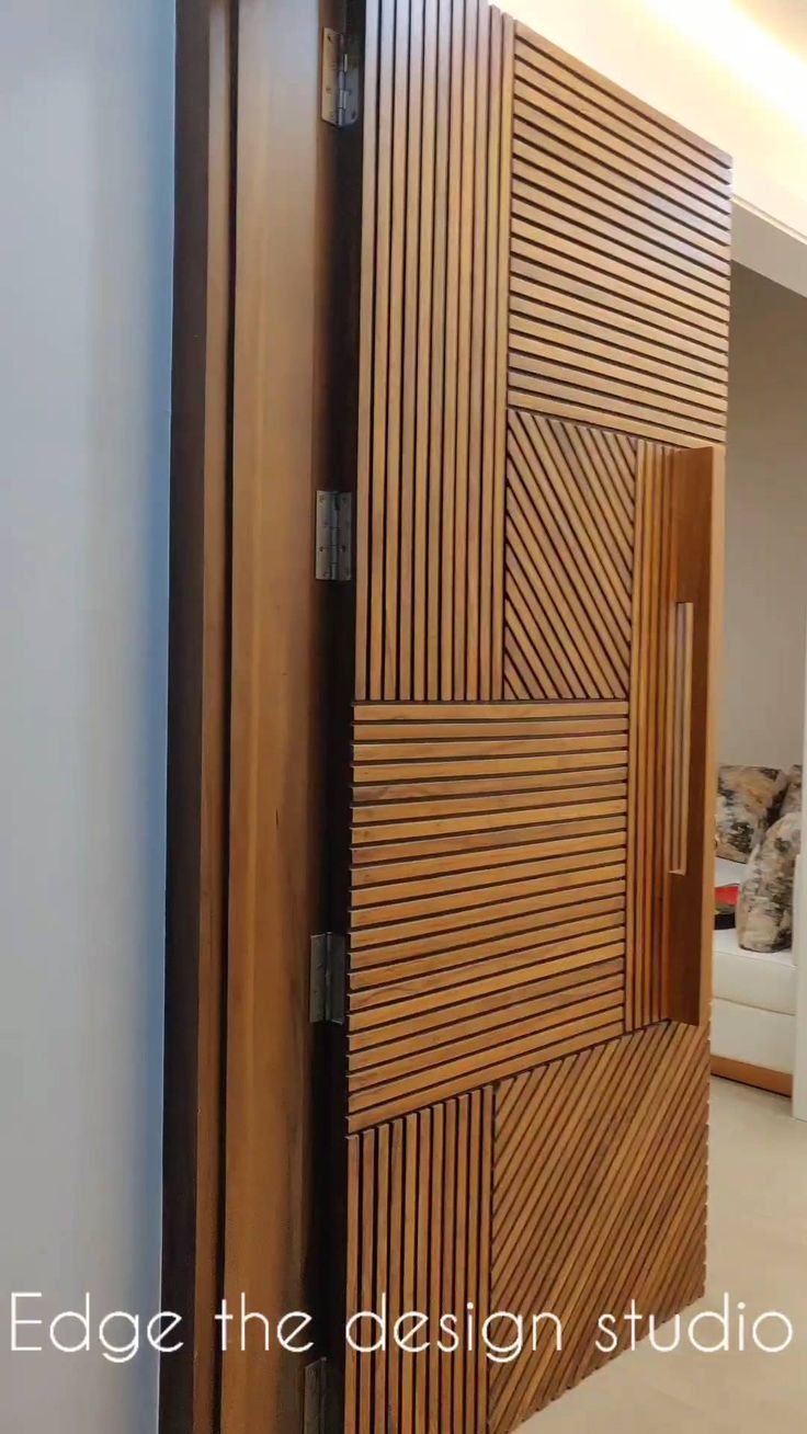 an open wooden door in the middle of a room with white walls and flooring