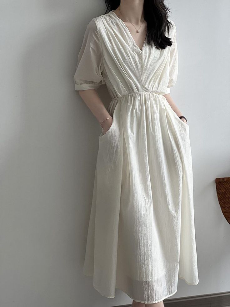 F00254835-103 White Pleated V-neck Maxi Dress, Vintage V-neck Dress For Summer Daywear, Elegant Beige V-neck Dress For Day Out, White Midi V-neck Dress For Spring, Elegant A-line Dress With Relaxed Fit, Cream Midi Dress For Spring Daywear, Solid Color V-neck Cotton Midi Dress, Spring V-neck Maxi Dress In Solid Color, Relaxed Fit V-neck Midi Dress