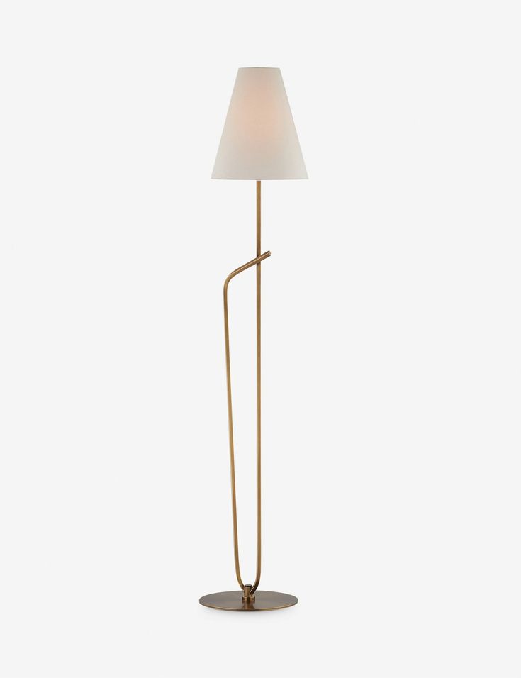 a floor lamp with a white shade on the top and an iron pole in the middle