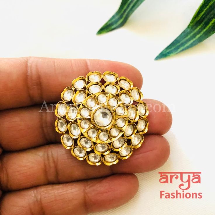 Tyaani Inspired Pacchi Kundan Golden Adjustable Ring Features: Adjustable Ring to match any finger size 22 Karat Gold Finish Lightweight Jewelry Made in Brass with very high quality Kundan stones Suitable for any occasion and traditional or Modern attire Ready to ship and available for local pickup from 23059. Please message us for more details Free shipping on orders above $75 within USA. Round Tilla Rings For Wedding, Traditional Adjustable Rings For Festive Occasions, Traditional Ceremonial Ring Jewelry, Kundan Rings For Festivals And Gifts, Tilla Rings For Wedding And Festivals, Flower Toe Ring With Stone Setting As Gift, Traditional Kundan Rings With Hand Set, Kundan Toe Ring As Gift, Stone Work Toe Ring Jewelry As Gift