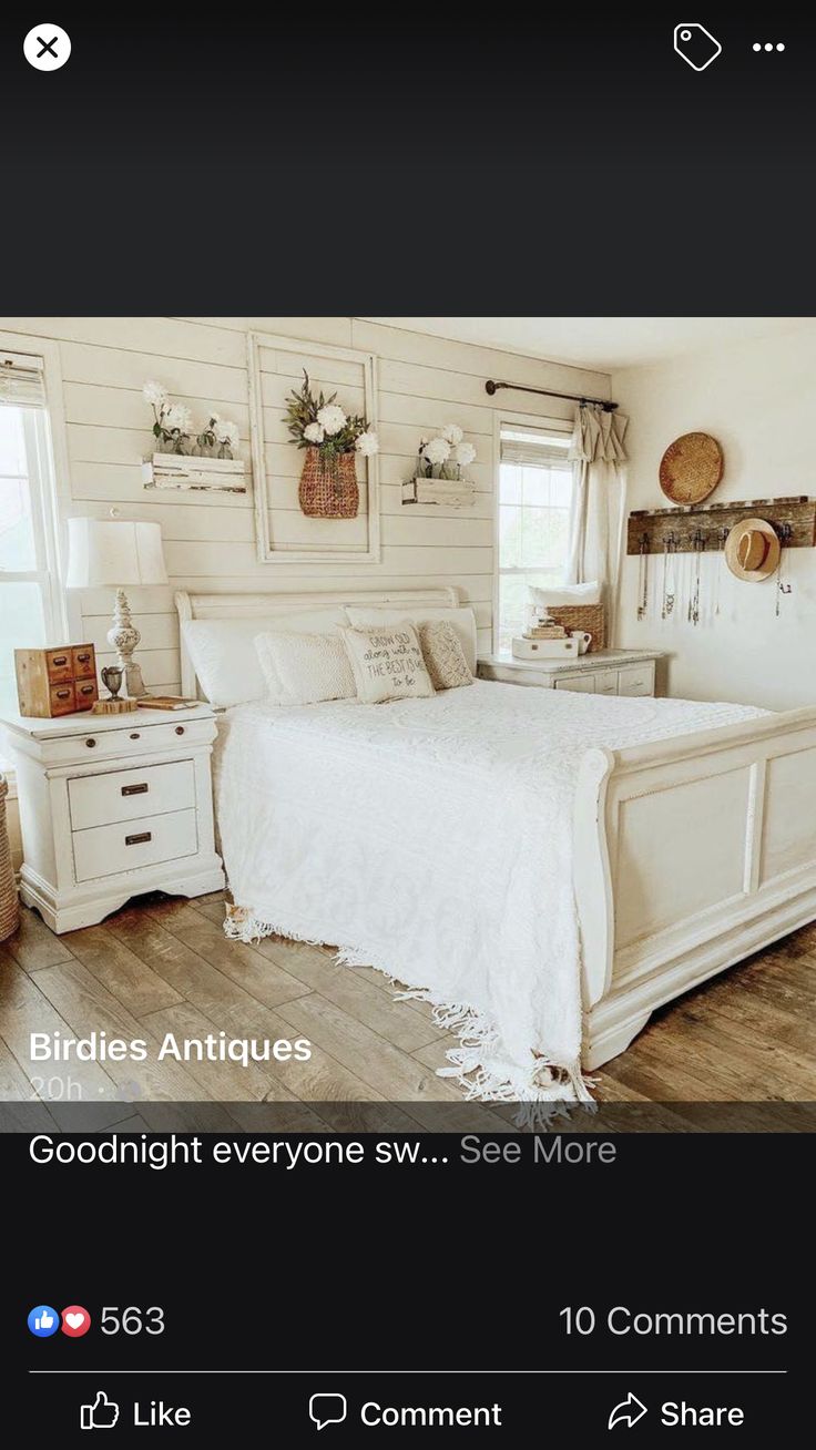 a bed room with a neatly made bed and white furniture