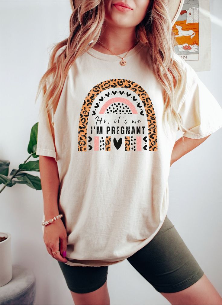 Introducing Hi, it's me. I'm Pregnant - the funny shirt to announce your big news! Let out a laugh and be proud of your baby bump with this unique tee. Show off that you're expecting in style and charm with this funny maternity shirt that is sure to put a smile on everyone's face. Built from high-quality fabric, this shirt is great for any season and is designed for optimal comfort without sacrificing style. Enjoy being the life of the party with the perfect accessory - whether people know what' Cotton Maternity T-shirt With Crew Neck, White Crew Neck Maternity T-shirt, Cute Maternity T-shirt With Letter Print, Cute Maternity T-shirt With Graphic Print, Cute Maternity Graphic Print T-shirt, Maternity Crew Neck T-shirt With Letter Print, Cute Maternity Cotton T-shirt, Maternity T-shirt With Graphic Print And Relaxed Fit, Maternity Cotton T-shirt With Letter Print