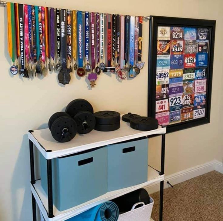 there are many medals hanging on the wall next to each other in this room with two blue bins