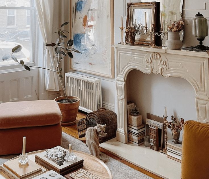 a living room filled with furniture and a fire place in front of a painting on the wall