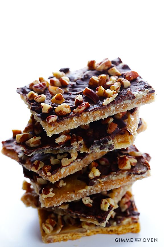 several pieces of chocolate and nuts stacked on top of each other in the shape of squares