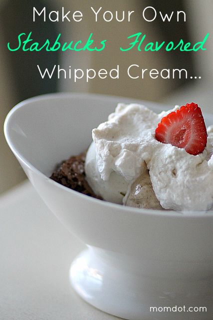 a white bowl filled with whipped cream and strawberries on top of it's side