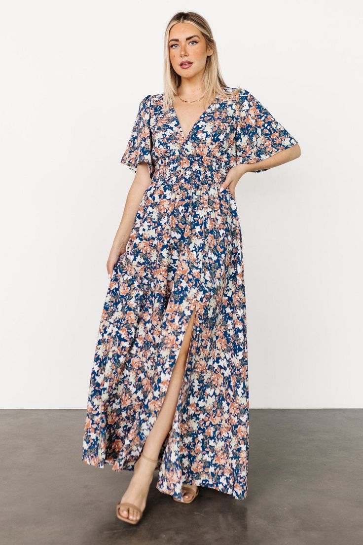 Flowy V-neck Breezy Maxi Dress, Fitted V-neck Breezy Maxi Dress, Flowy V-neck Lined Maxi Dress, Modest V-neck Maxi Dress For Day Out, Blue V-neck Maxi Dress With Smocked Back, Flowy V-neck Maxi Dress With Elastic Sleeves, Flowy Floral Print Maxi Dress, Bohemian Maxi Dress With Smocked Bodice For Casual Wear, Chic Billowy Smocked Bodice Maxi Dress