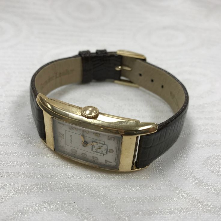 "PLEASE READ ENTIRE DESCRIPTION BEFORE PURCHASING For Sale: (1) a140 Vintage Original Longines 14K Gold Mechanical Hand Winding Wrist Watch Please see pictures for more details! Pre-owned: Some scratches from normal wear. Face shows some discoloration, see photos for details. Watch is working and keeping time well. Watch is in great mechanical condition, all of our watches are tested for time by one of our watchmakers before being listed for sale. All vintage/antique items sold as is with no war Classic Collectible Watch With Rectangular Dial, Classic Watches With Rectangular Dial For Collectors, Classic Collectible Watches With Diamond Hour Markers, Classic Yellow Gold Bracelet Strap Watch Bands, Classic Collectible Analog Watch Accessories, Classic Yellow Gold Watch With Bracelet Strap, Classic Yellow Gold Watch Accessories With Bracelet Strap, Classic Yellow Gold Watch Bracelet Strap, Classic Formal Watch With Bracelet Strap