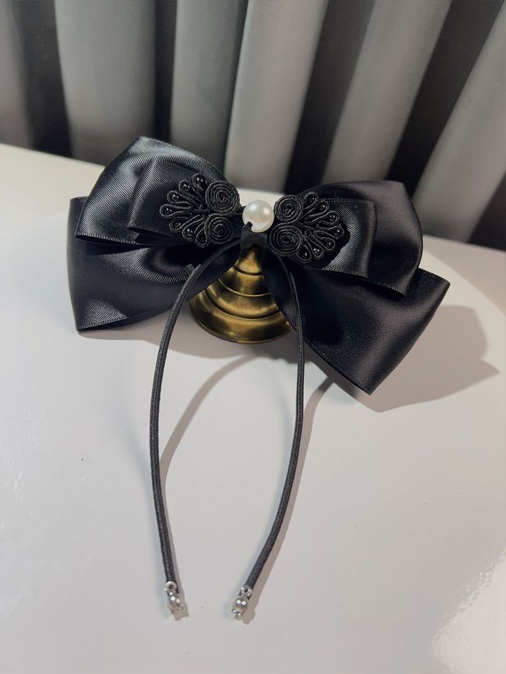 a close up of a black bow on a table