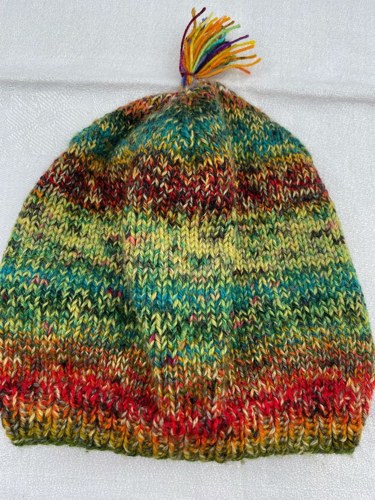 Multicolored hat Size: 48 cm in circumference, H 23,5 cm, very stretchable Removable tassel Combination of exclusive yarns 75 % wool, 25 % polyamid Knitted One Size Bonnet, One Size Knitted Bonnet, One Size Knitted Bonnet Hat, Brimmed Multicolor Hats For Fall, Multicolor Brimmed Hats For Fall, Multicolor Brimmed Fall Hats, Fall Multicolor Brimmed Hat, Multicolor Wool Hat For Fall, One Size Knit Bonnet Cap