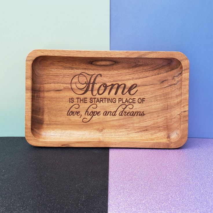 a wooden tray that says home is the starting place of love, hope and dreams