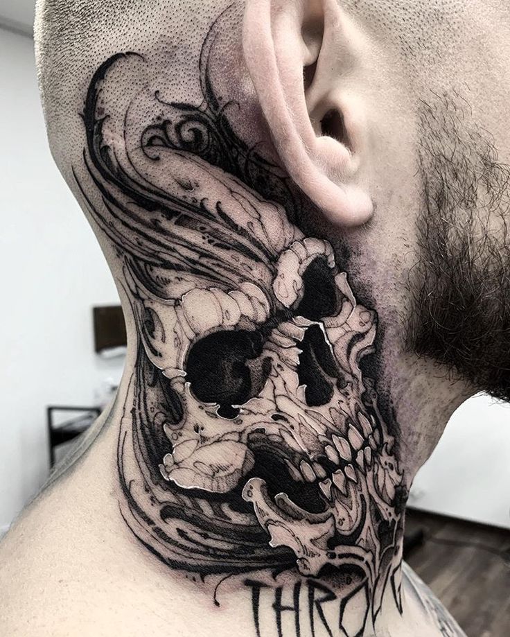 a man with a skull tattoo on his neck