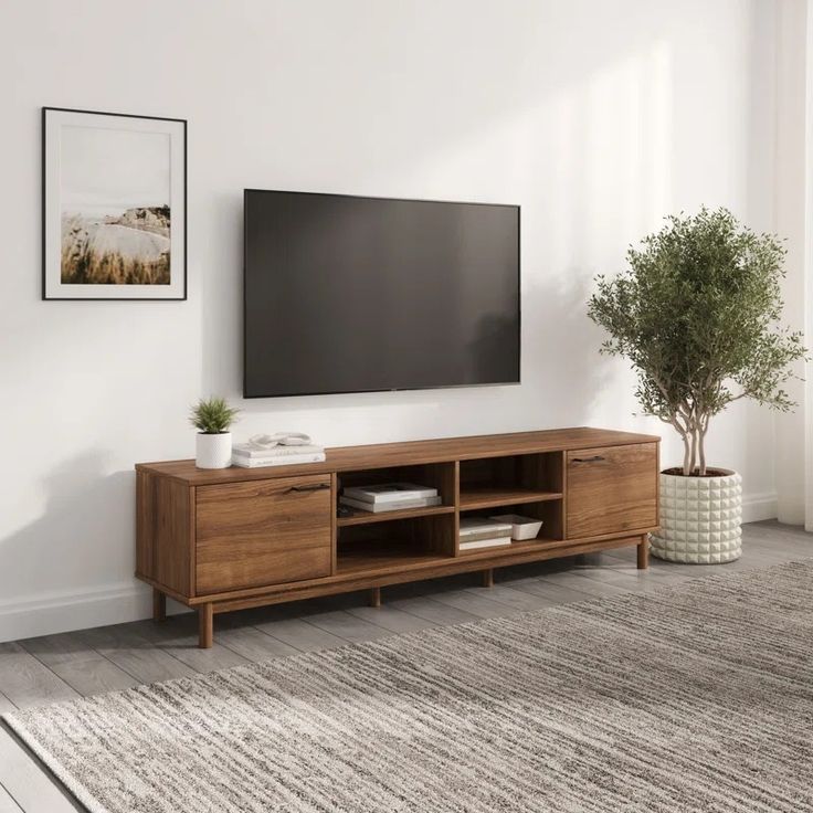 a large flat screen tv mounted to the side of a wooden entertainment center in a living room