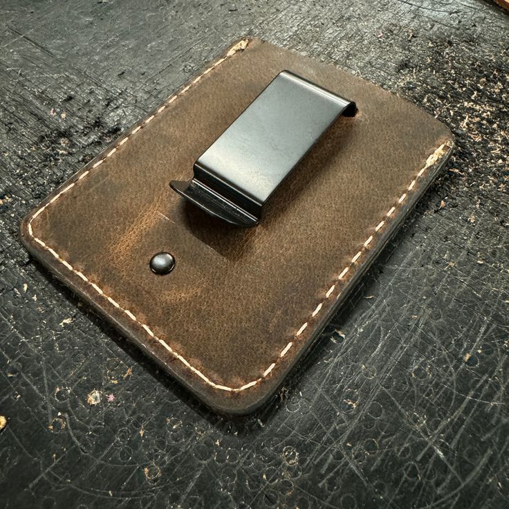 a leather wallet with a lighter in it