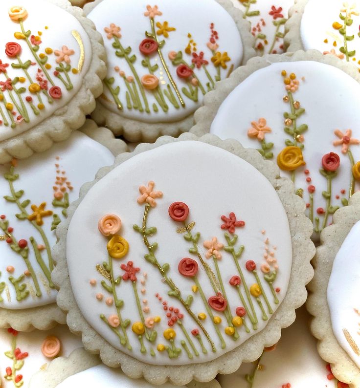 decorated cookies with flowers and leaves on them