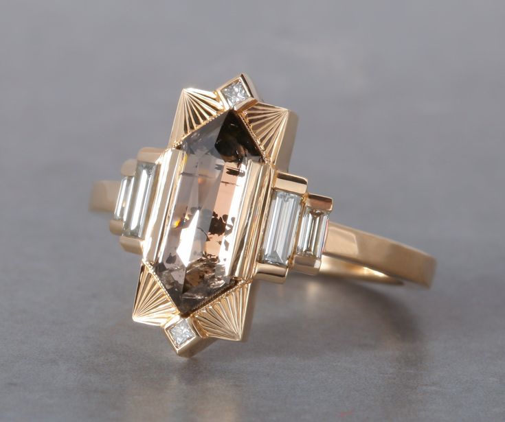 Named after Hilma AF Klint. This new setting was a dream ring we had been envisioning in the back of our minds for some time. For our first ring we chose this lovely 1.74ct Champagne Rosecut Elongated Hexagon Diamond and we accented it with some good size diamond baguettes and a few princess diamonds on the top and b Saphire Engament Ring Bezel, Unique Witchy Engagement Rings, Art Deco Fine Jewelry, Art Deco Ring Vintage, Architectural Engagement Ring, Gold And Black Engagement Ring, Artemer Engagement Rings, Elongated Hexagon Ring, Dream Engagement Rings Gold