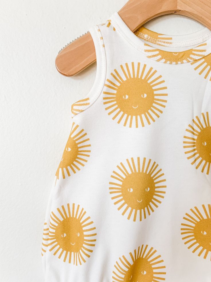 Your little will look super cool while staying cool in this bubble romper! So perfect for layering in cooler weather, and on it's own for hot summer days! This romper is sewn up in a super cute sunshine print. Pair it with the matching shorts and peplum tank for a sibling set! This stylish bodysuit features cotton produced in the USA that is certified organic by global organic textile standards so you can feel good about dressing your baby in it! We serge all seams for added durability and stren Sleeveless Bodysuit For Summer Playwear, Fun Cotton Bodysuit For Spring, Summer Cotton Bodysuit For Playwear, Playful Spring Onesie For Playwear, Cute Spring Bodysuit For Playwear, Playful Summer Playwear For Babies, Summer Bubble Romper For Playtime In Spring, Playful Bubble Romper For Summer Playwear, Summer Bubble Romper For Spring Playdate