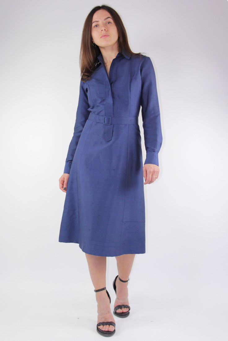 "SIZE: fits EU 36, UK 10, USA 6, general size S MATERIAL: 100% silk COLOR: night sky blue FEATURES: this silk dress is tailored of a soft yet thick low sheen silk fabric with rough finish on outside, but satin soft and shiny inside which is strong, durable and wrinkle resisting. The dress is slightly tailored at waist with soft A-line skirt and is intended to hit just bellow knee length. It has a belt with same material covered buckle around waist to accentuate a feminine figure. Feels close to Classic Blue A-line Midi Dress, Silk Midi Dress For Office, Formal Long Sleeve Silk Shirt Dress, Classic Silk Office Dress, Silk Long Sleeve Shirt Dress For Office, Long Sleeve Silk Shirt Dress For Office, Fitted Silk Mid-length Dress, Fitted Mid-length Silk Dress, Fitted Belted Shirt Dress For Formal Occasions